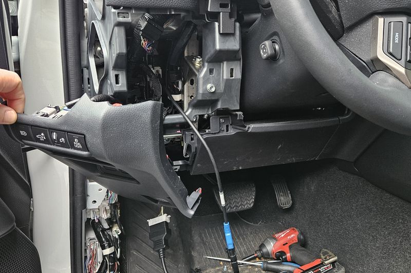 A truck's steering column opened up with the shroud removed to reach the ignition lock cylinder.