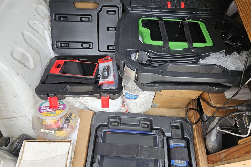 Key programming tablets and tool cases packed in the back of the locksmith van.